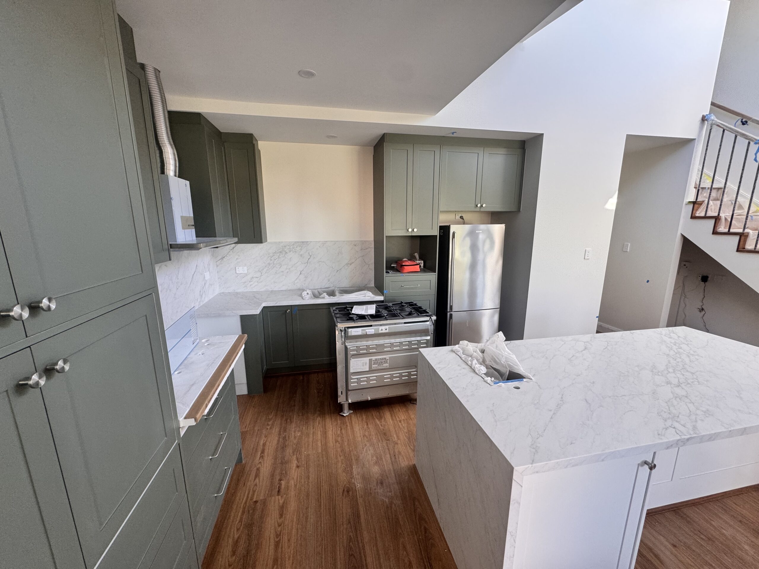 Open plan kitchen space with premium flooring and seamless appliances
