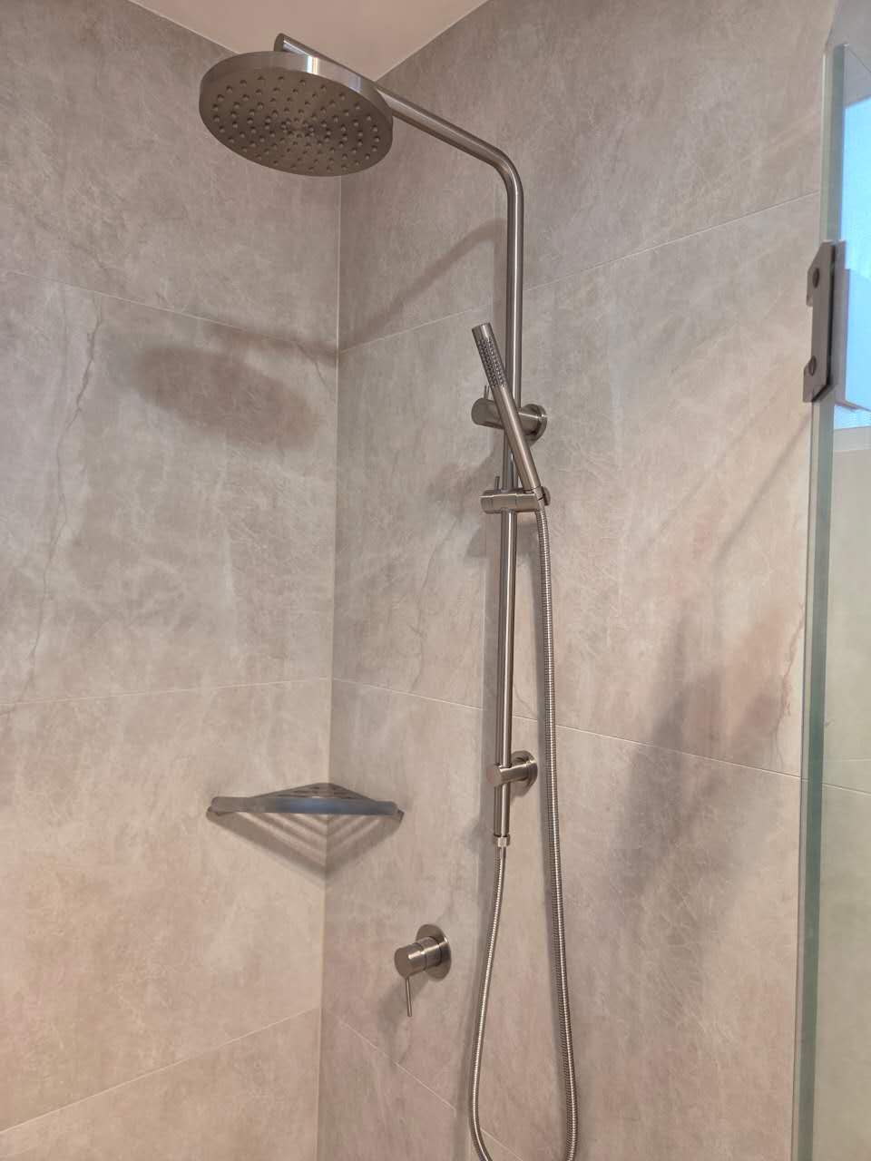 Brushed metal shower fittings in completed Sylvania Waters bathroom